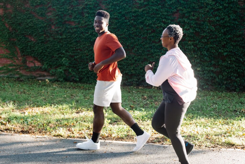 Man and woman jogging together outdoors on a sunny morning